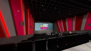 Arc Cinema theatre area with black seats and red walls